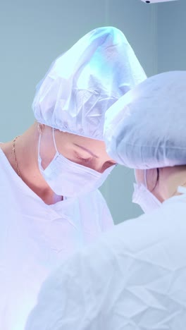 medical professionals in surgical attire collaborating in a bright operating room environment