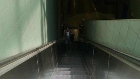 woman on escalator in subway station