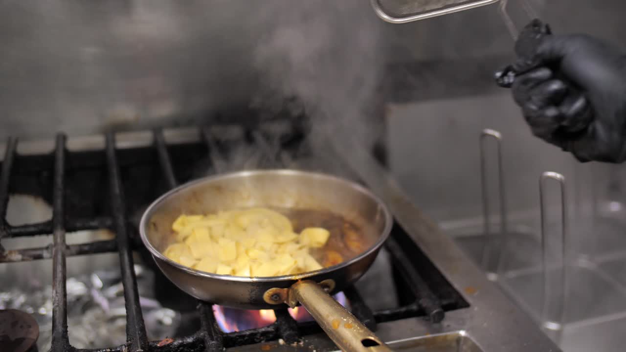 Adding fresh boiled pasta to meat ragout frying on pan, close up
