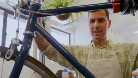 man repairing bicycle in workshop 4k