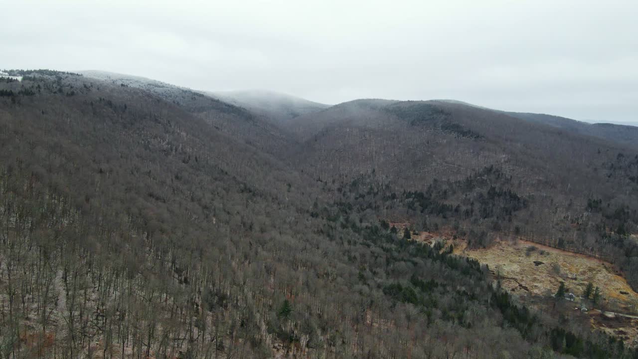 una foto de un dron de una nube de nieve nevando en las montañas en vermont, nueva inglaterra