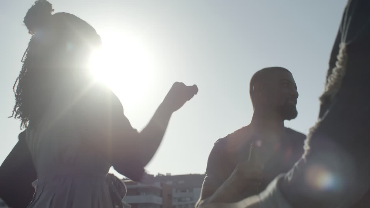 Smiling African American woman with dreadlocks dancing