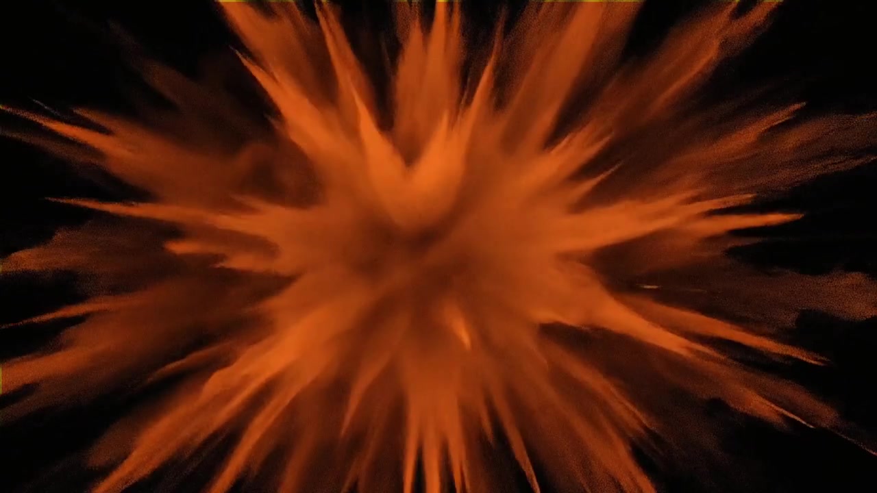 Orange Powder Explosion Against Black Background