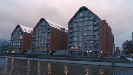 buildings with snowed roofs in a row near the motlawa river at gdansk poland