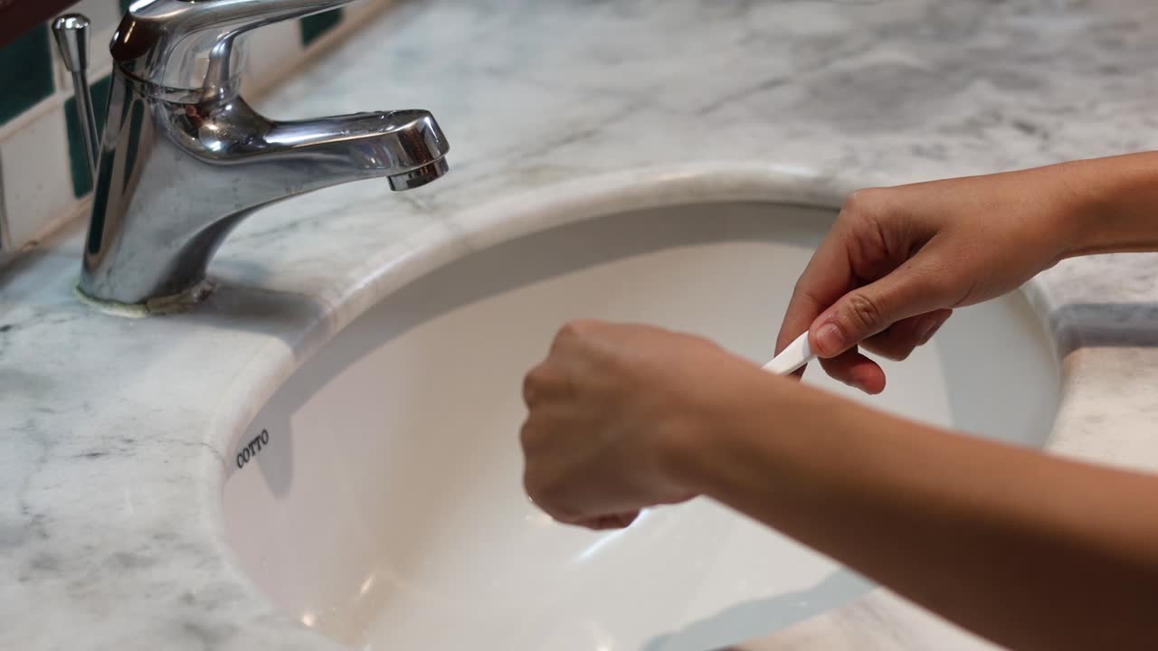 Sequence of applying toothpaste onto a toothbrush