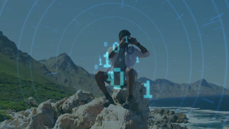 animation of binary codes, circles over african american man looking through binoculars at outdoor