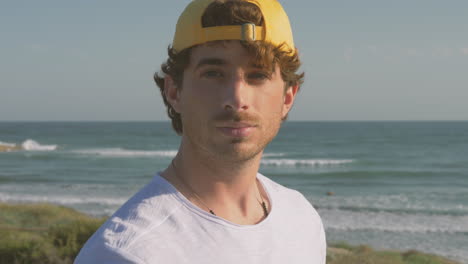 portrait of athlete man with cap smiling and looking at camera