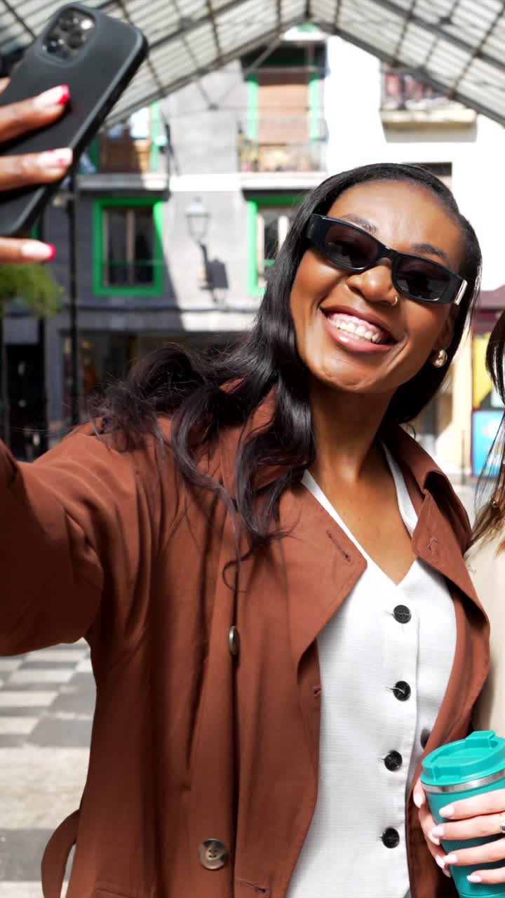 Two women taking a selfie in the city
