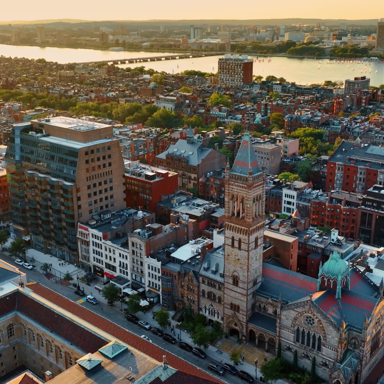 Bright diverse old architecture of Boston downtown at sunset. Rays of sun light the numerous buildings and the Charles River. Aerial view