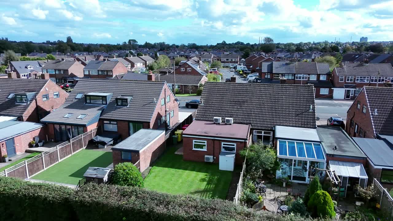 Suburban retirement village homes in row aerial view across typical English landscaped back gardens