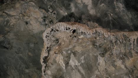 light moving on big stalactite structure inside a cave