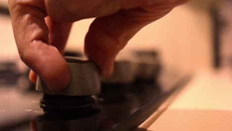 kitchen-gas-cooker-controls-close-up---pushing-a-control-knob-to-turn-on-the-stove-macro---daily-actions-concept