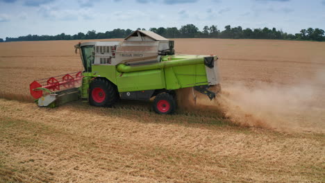 combine harvester working in wheat field