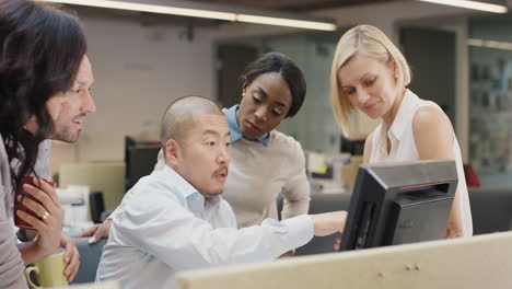 japanese businessman leading creative business team meeting.happy people working in modern office at night discussing strategy using computer touch screen in diverse gender group