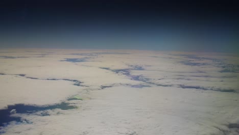 big white clouds over the atlantic ocean with black space over the curvature of the earth