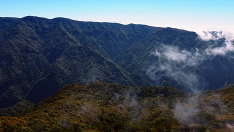 breath-taking view of the high mountains in the madeira islands, portugal. light clouds float above the rocks. aerial view.