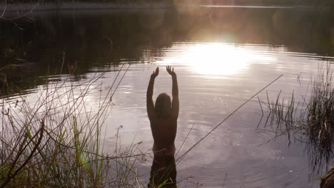 back view of a half-naked woman ready to swim on a calm blue lake at naree budjong djara national park, north stradbroke island, queensland australia