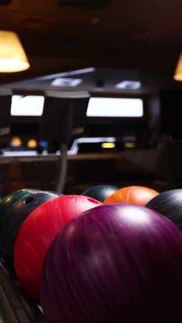 people selecting bowling balls at a bowling alley