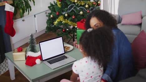 Happy-african-american-mother-and-daughter-using-laptop-with-copy-space-on-screen