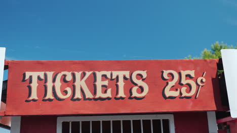 ancient sign on ticket kiosk with price for rides