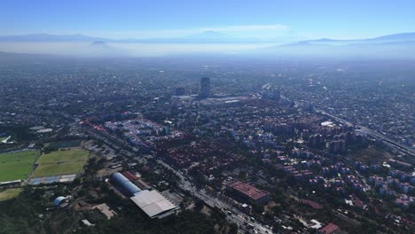 aerial flight at high altitude over mexico city on a misty morning