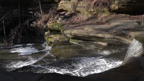 majestic rocky landscape and forest river streaming down stone steps