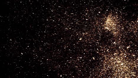 beautiful golden flying dust particles with on black background. animation. fast motion of shining dots moving chaotically in the dark