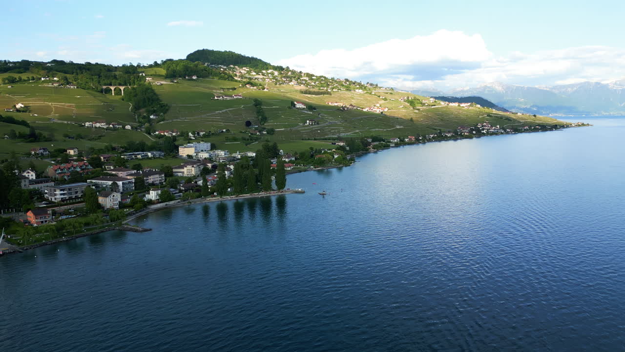 Push in drone shot of Lavaux terraced vineyards and Lake Geneva during the day near Lutry in canton of Vaud, Switzerland