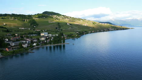 push in drone shot of lavaux terraced vineyards and lake geneva during the day near lutry in canton of vaud, switzerland