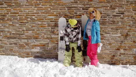 Snowboarder-with-happy-friend-in-front-of-wall