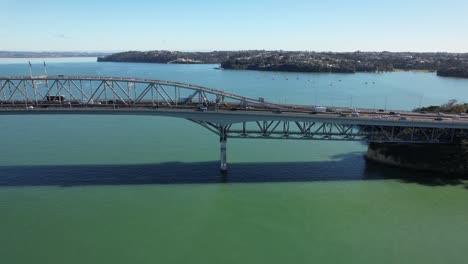 Auckland-Harbor-Bridge-With-Driving-Vehicles-In-New-Zealand---Drone-Shot