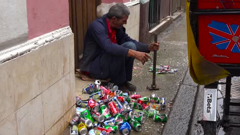 Ein-Mann-Auf-Der-Straße-Zerquetscht-Und-Recycelt-Aluminiumdosen-In-Havanna-Kuba-1