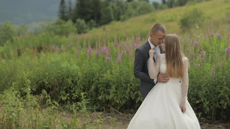 Groom-with-bride-together-on-a-mountain-hills.-Wedding-couple.-Happy-family