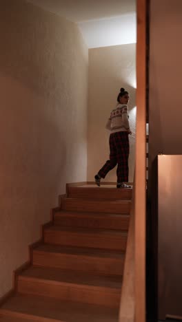 woman walking up the stairs in a house