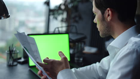 businessman looking at graphs on documents. employee talking during video call