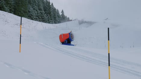 a snow cannon shoots snow on the slope