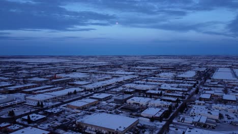 industrial zone at night with moon in the background