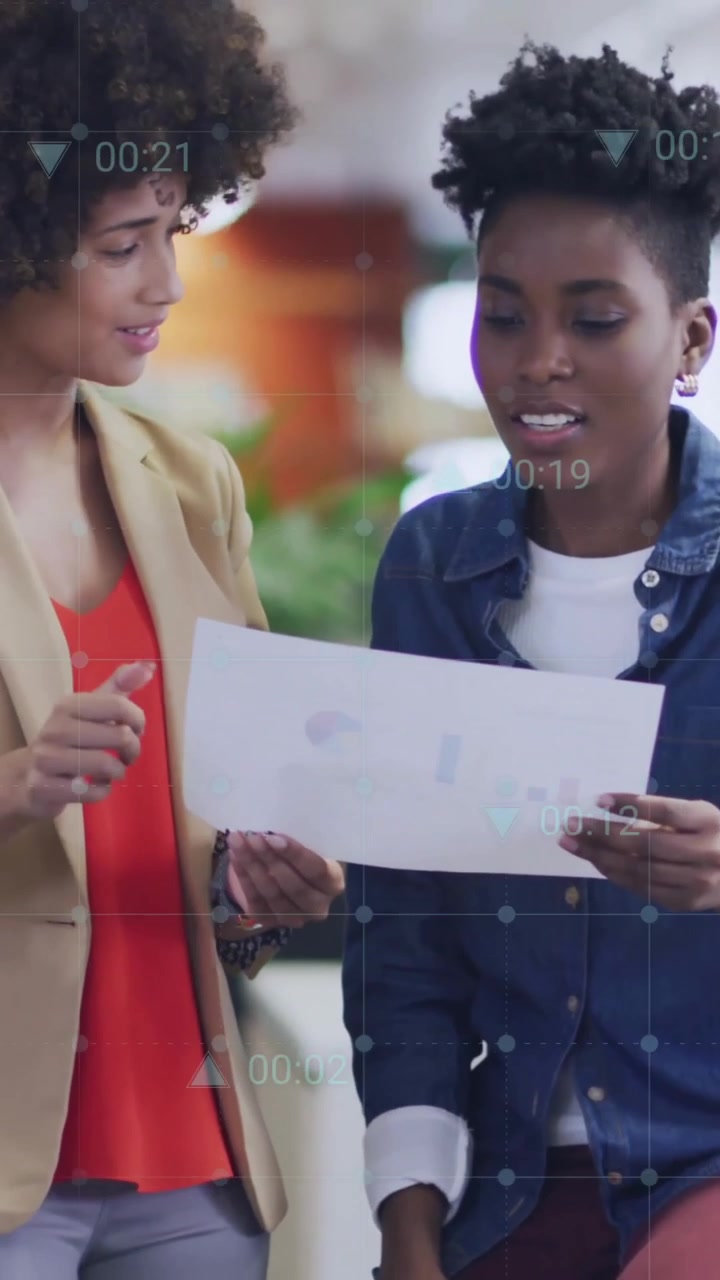 Animation of diagram and data processing over female colleagues talking in office