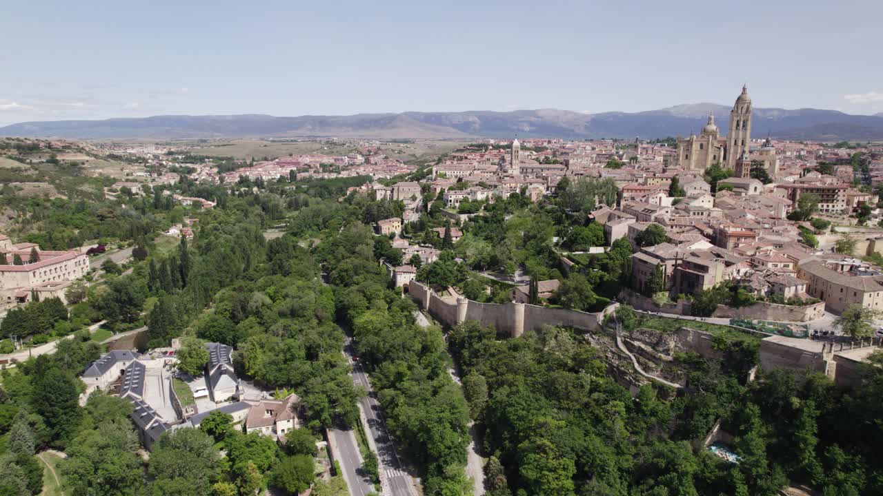 Aerial view circling lush greenery surrounding Segovia historic city northwest of Madrid, in central Spain's Castile and Le&oacute;n region