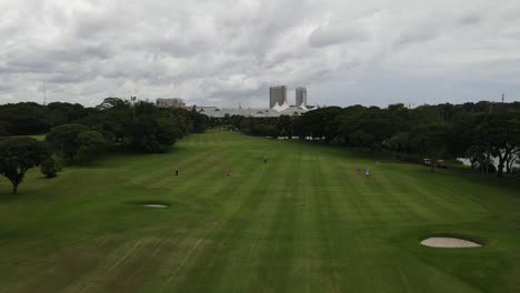 Aerial-view-of-golf-course-with-golfer-playing-golf