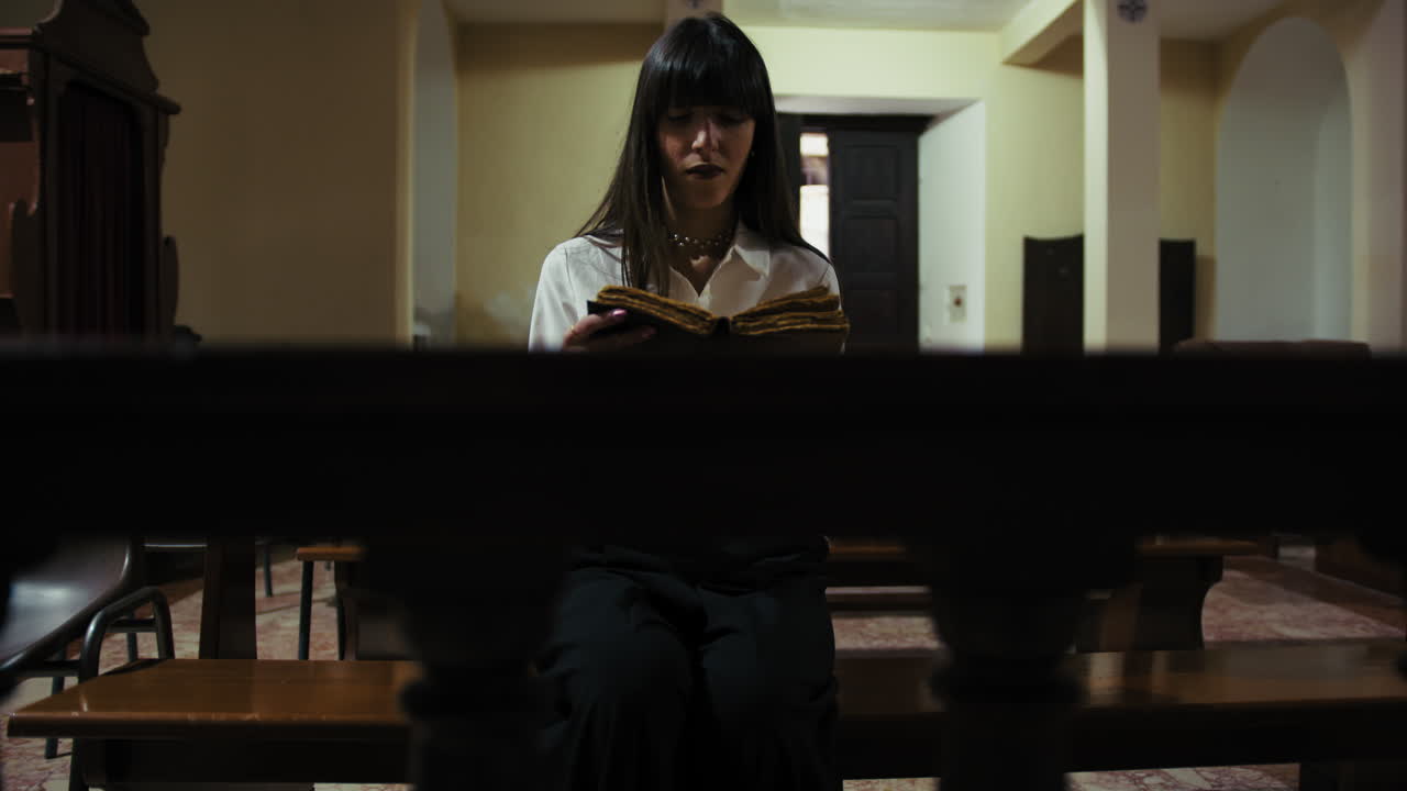 Devoted Young Woman Reading Prayers In The Church On The Sacred Book