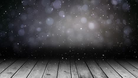 Animation-of-snow-falling-over-glowing-spots-of-light-with-copy-space-and-wooden-surface