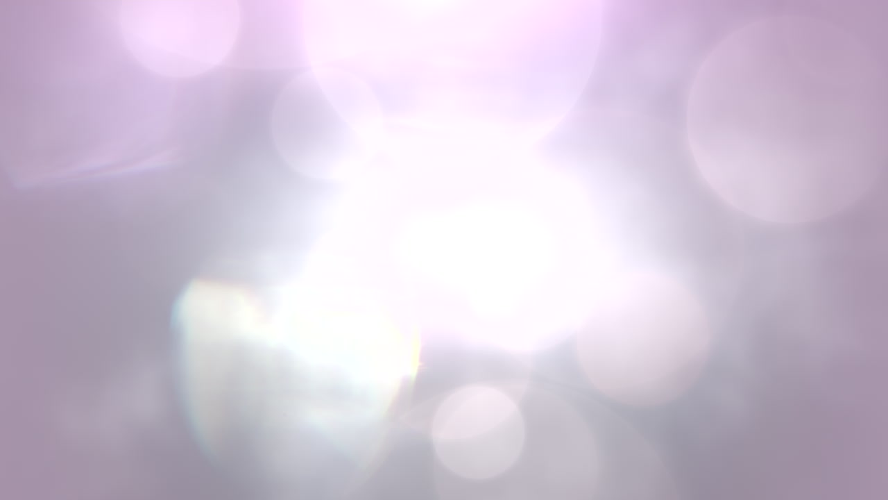 volar partículas blancas y moradas románticas con bokeh redondo