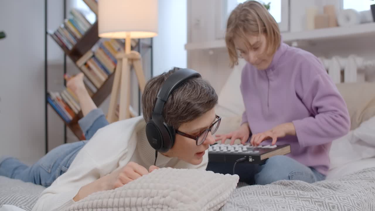Teenage girls making music in bedroom
