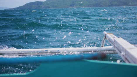 boat outrigger crashing into blue waves slow-mo 4k