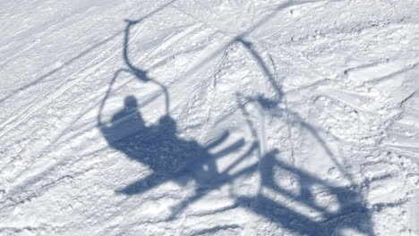 traveling about the shadow of two skiers on the lift in baqueira beret - pyrenees