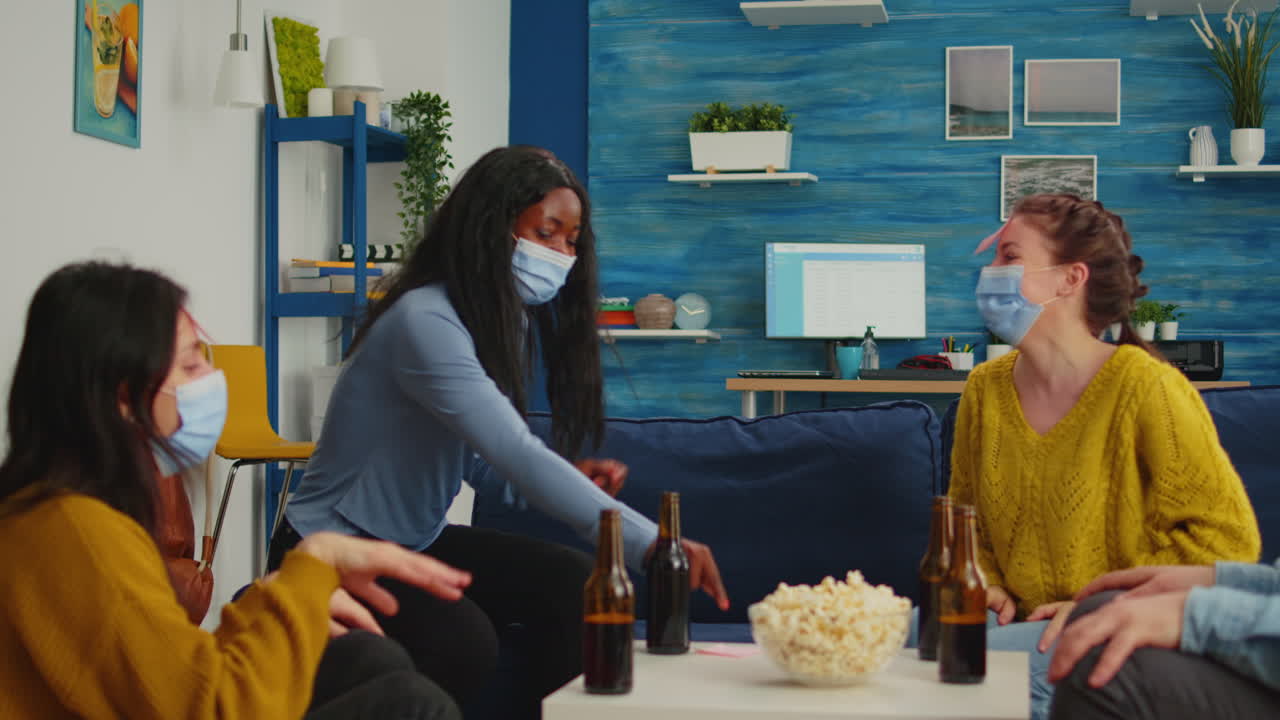 African woman with face mask playing name game with happy friends