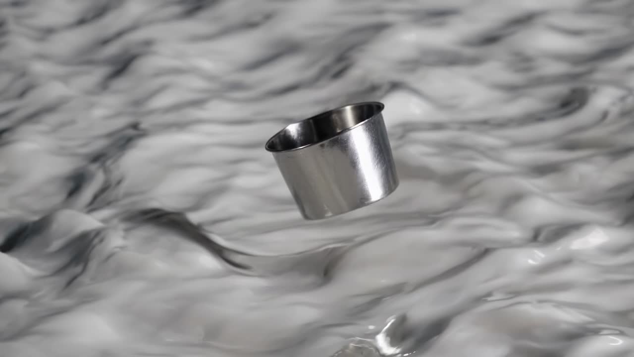 Metal Cup Floating in Milk