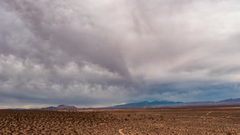 clouds roll in over the mojave desert basin and joshua trees - sliding parallax aerial hyper lapse