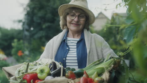 senior woman enjoying fresh harvest in garden